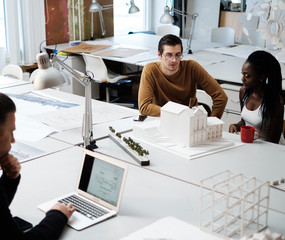 Multiracial team working in design and engineering architecture office.
