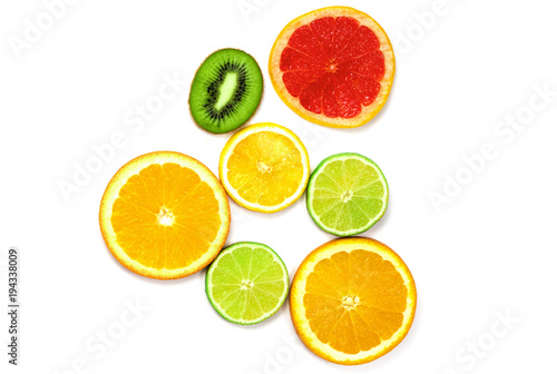 pieces of orange lemon  kiwi  and greyfruit and lime on a white background