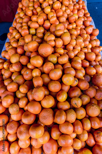 Huge pile of oranges for sale at a farmers market.
