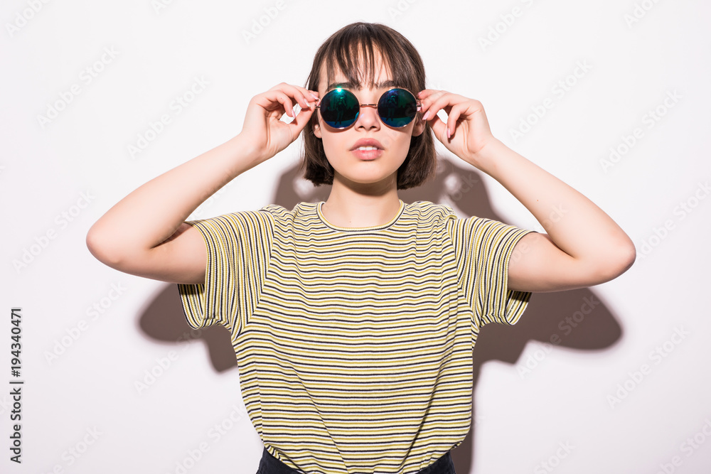 Portrait of happy teenage girl in sunglasses isolated on white background