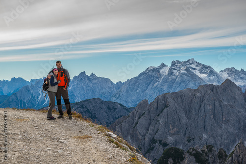 young couple in italien dolomites, loving nature and climbing, tre cime di lavaredo