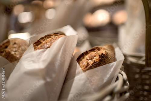 French bread baguettes in paper bags from bakery. Selective focus.