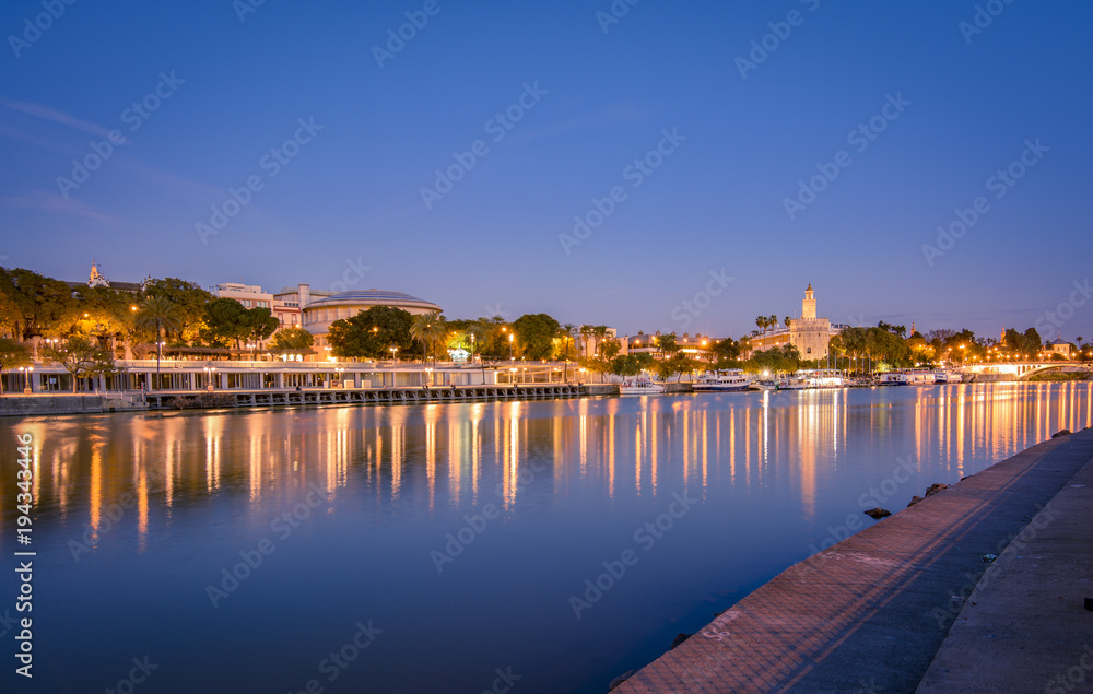 Blue hour view of Seville from Triana quarter.