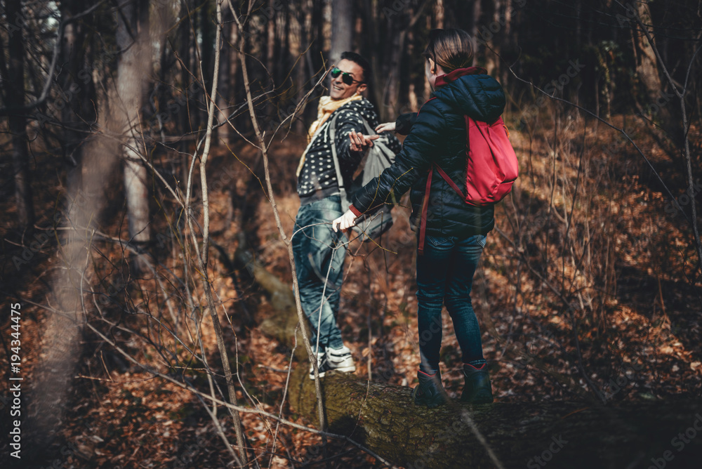 Obraz premium Father giving hand to a daughter in the forest