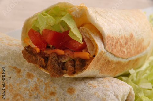 mexican Burrito meal with tomatoes and meat.