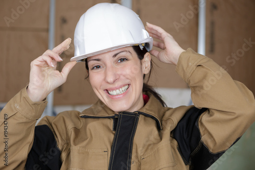 female worker with hard hat smiling