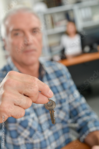 Estate agent holding out a key