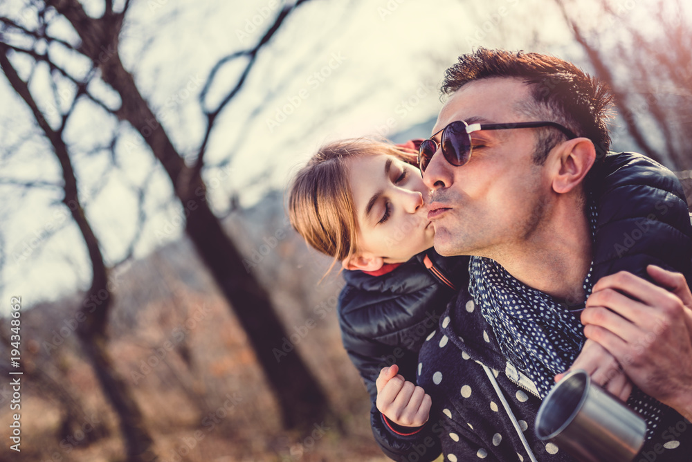 Daughter kissing and embracing her father Daughter kissing and embracing her father