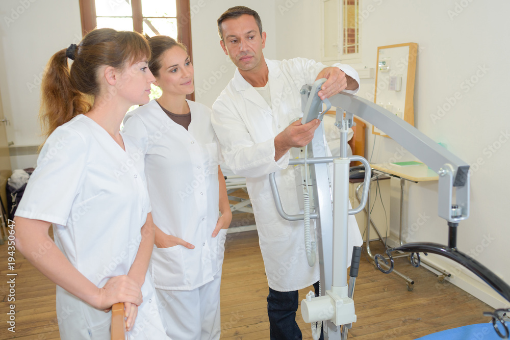 two homecare nurses learning how to use a hoist two homecare nurses learning how to use a hoist