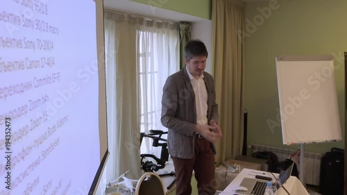 Man speaking at conference teacher photo