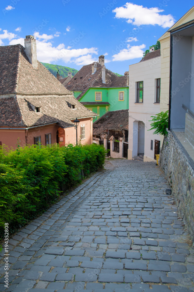 Narrow medieval street in Sighisoara, Romania, Europe