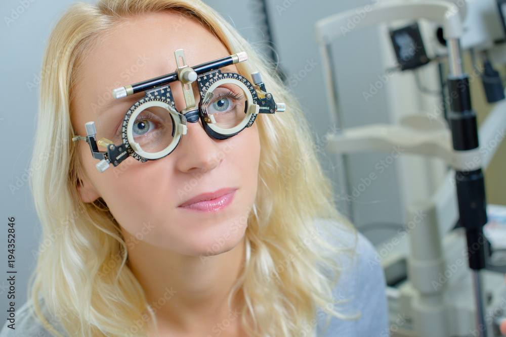 Lady wearing opticians testing glasses Lady wearing opticians testing glasses