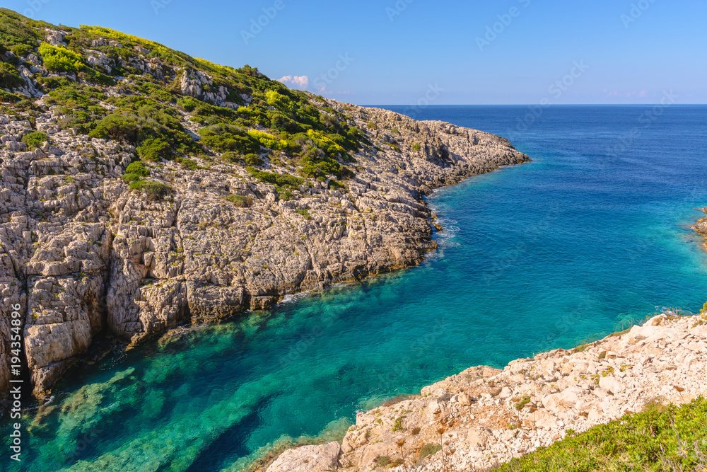 Beautiful blue water and cliff near Agios Leon village on western side of Zakynthos island. Zante, Greece Beautiful blue water and cliff near Agios Leon village on western side of Zakynthos island. Zante, Greece