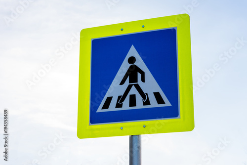 Pedestrian crossing road traffic sign in yellow frame