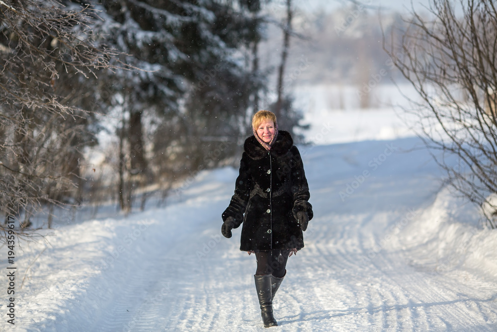 Full-length portrait of a young woman in snowy weather. Full-length portrait of a young woman in snowy weather.