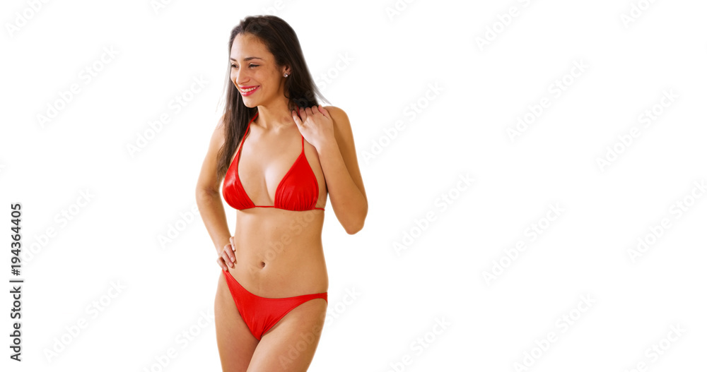 A Hispanic girl plays around on a white background in her red bikini. A Latina  woman acts playful on a blank backdrop Stock Photo | Adobe Stock