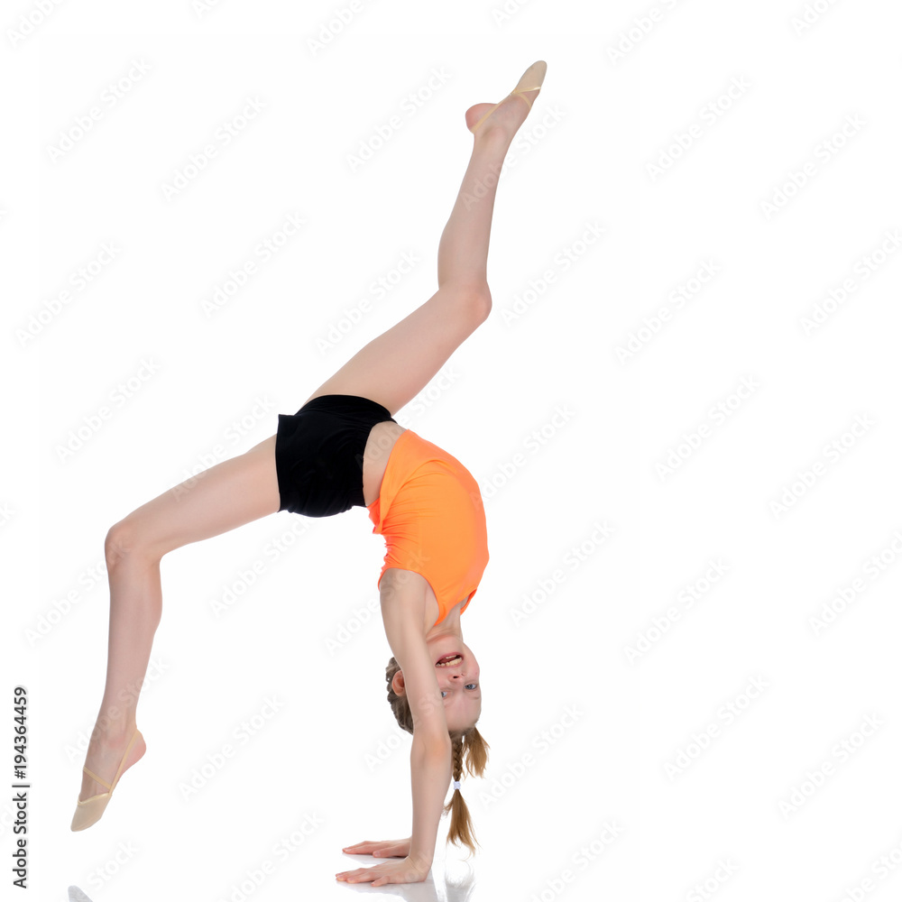 The gymnast performs a handstand with bent legs. The gymnast performs a handstand with bent legs.