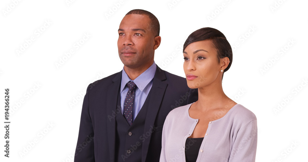 Black business couple posing for a portrait on a white background. African American people standing on a blank backdrop Black business couple posing for a portrait on a white background. African American people standing on a blank backdrop