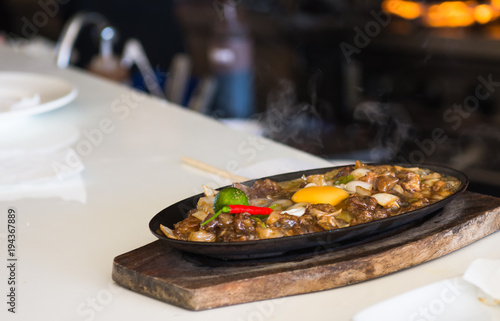 sizzling pork sisig with raw egg