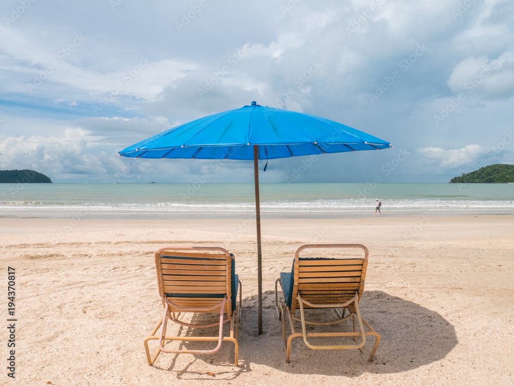 Beach Chair and Blue Umbrella in Sunny Day