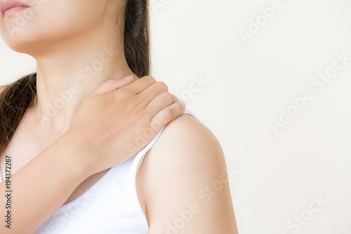 Closeup woman shoulder pain and injury. Health care and medical concept.