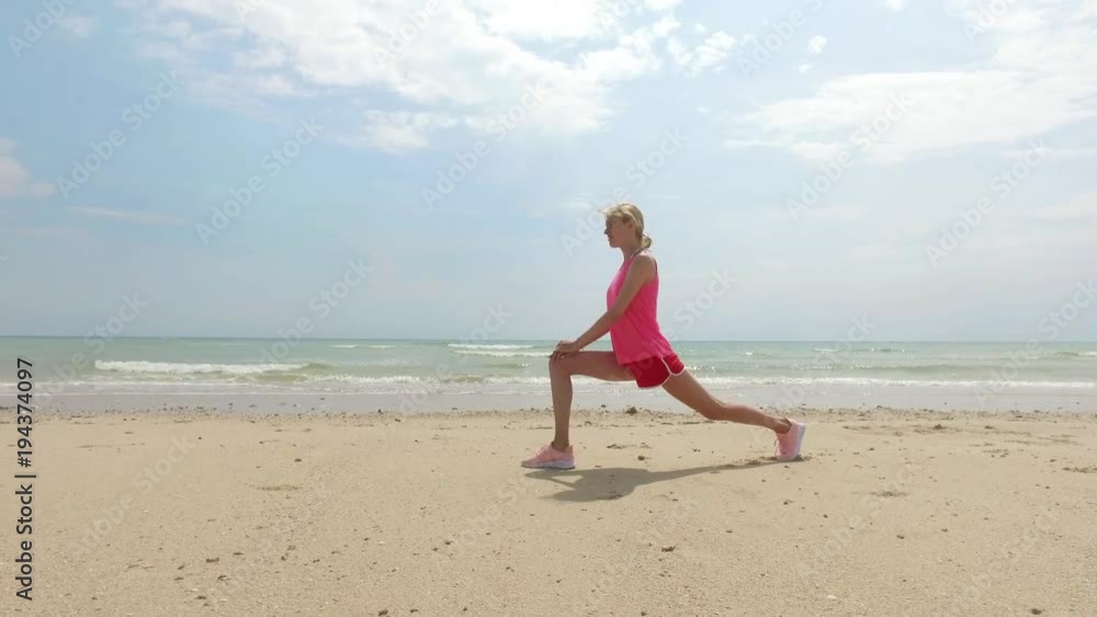sports woman doing warm-up on the beach sports woman doing warm-up on the beach