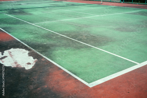 Old and vintage of green tennis court, The field line and corner of court, Dirty ground of tennis court.