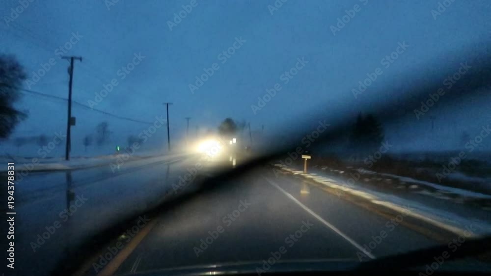 Windshield view noir style shot of car driving at night in low moving fog. Windshield view noir style shot of car driving at night in low moving fog.