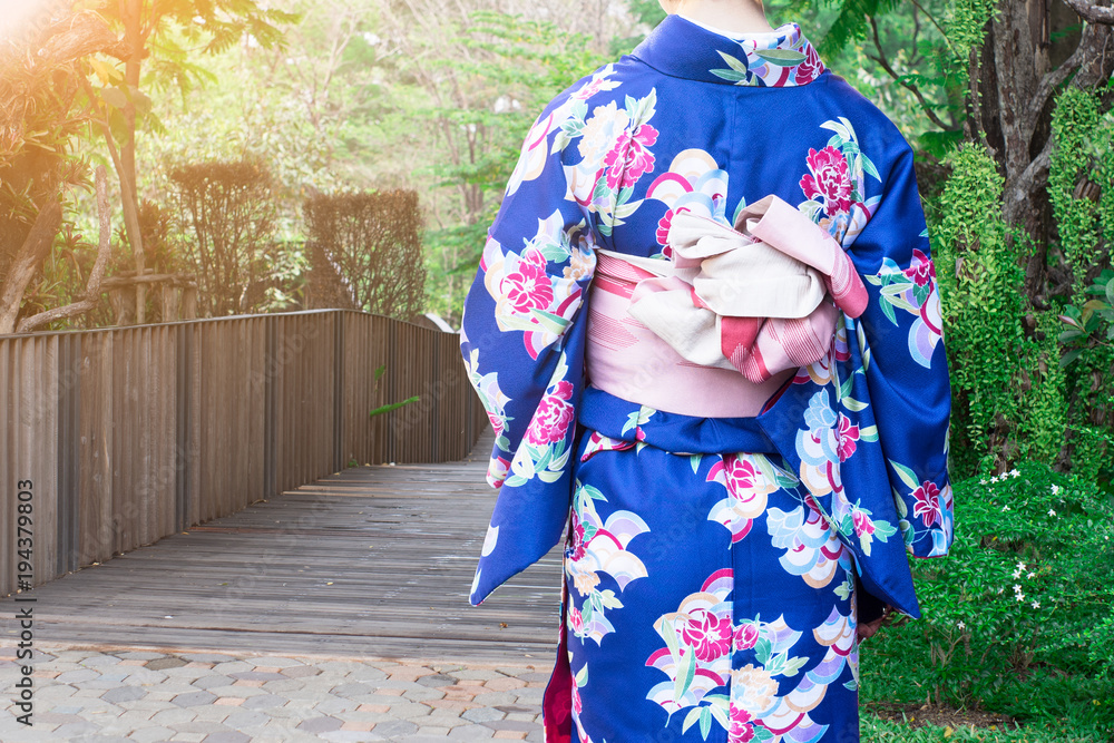 Woman wearing Kimono traditional Japan walking on wooden bridge at park. Woman wearing Kimono traditional Japan walking on wooden bridge at park.