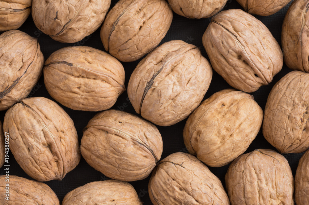 Background of walnuts in a shell. Texture of walnuts. Healthy organic food. View from above. Macro. Background of walnuts in a shell. Texture of walnuts. Healthy organic food. View from above. Macro.