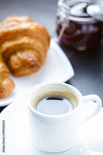 cup of coffee and croissants on the morning table