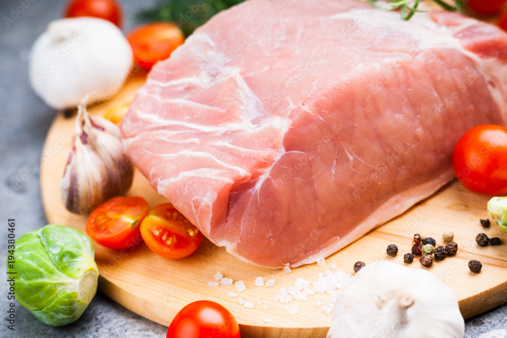 Raw pork on cutting board and vegetables Raw pork on cutting board and vegetables