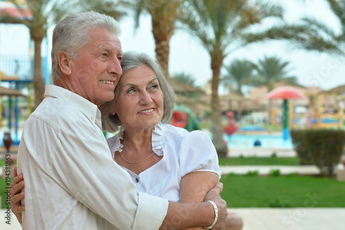  Senior couple at  hotel resort hugging