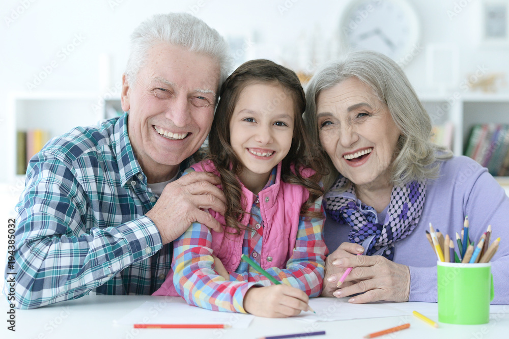 little cute girl with grandparents studying little cute girl with grandparents studying