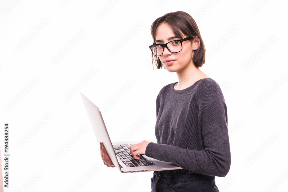 Portrait of a smiling teen girl holding laptop computer isolated on a white background Portrait of a smiling teen girl holding laptop computer isolated on a white background