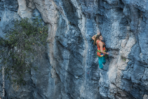 Blonde girl climbs tufa rock, Chitdibi, Turkey