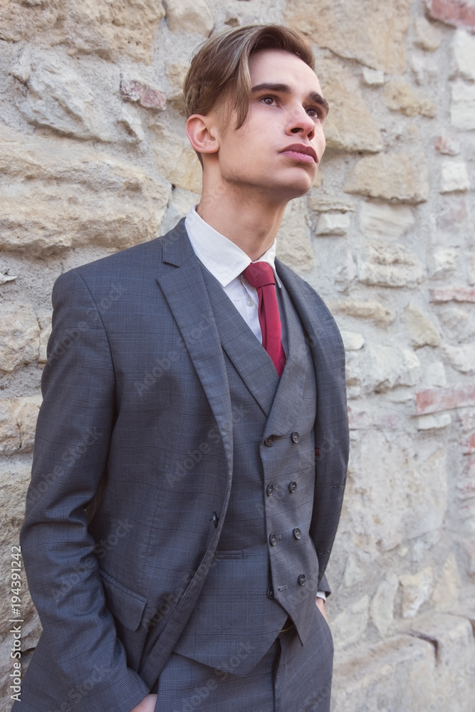 Confident young man in suit and red tie Confident young man in suit and red tie