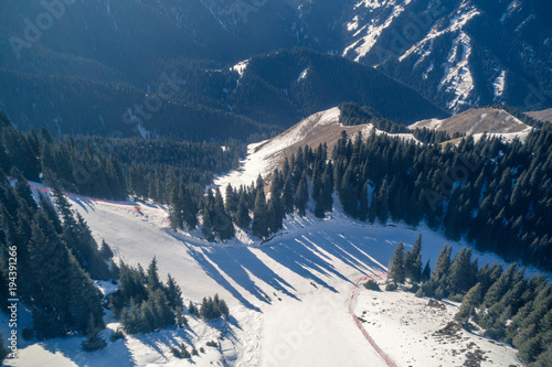 Aerial view of the Alpine skiing and snowboarding piste in mountains