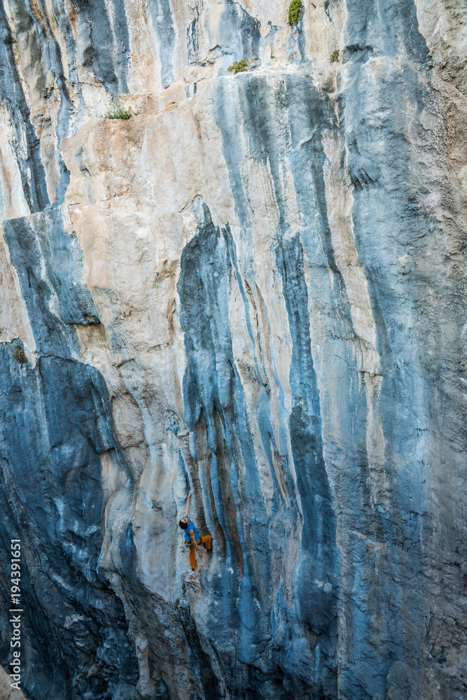man climbs tufa rock, Chitdibi, Turkey man climbs tufa rock, Chitdibi, Turkey