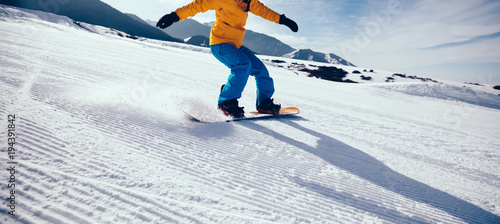 Vászonkép snowboarder snowboarding in winter mountains