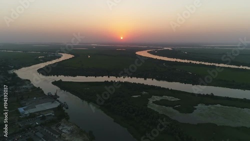 Wallpaper Mural Aerial footage of a river branches with a village and industrial area at the shore at sunset Torontodigital.ca