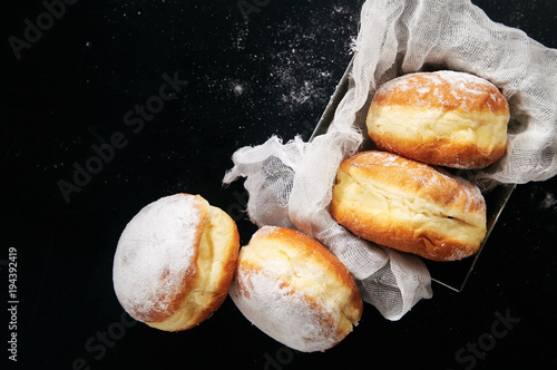Sufganiyot donuts with jelly on black background. Copy space