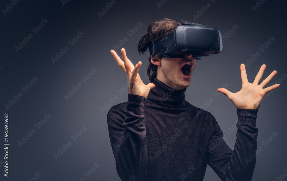 Portrait of a man wearing virtual reality device isolated on a d Portrait of a man wearing virtual reality device isolated on a d