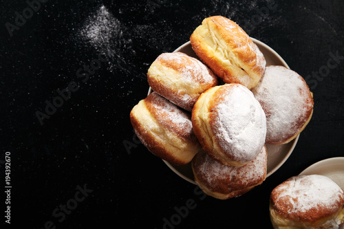 Sufganiyot donuts with jelly on black background photo