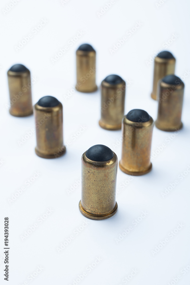 Old rubber bullets on a white background, selective focus. Old rubber bullets on a white background, selective focus.