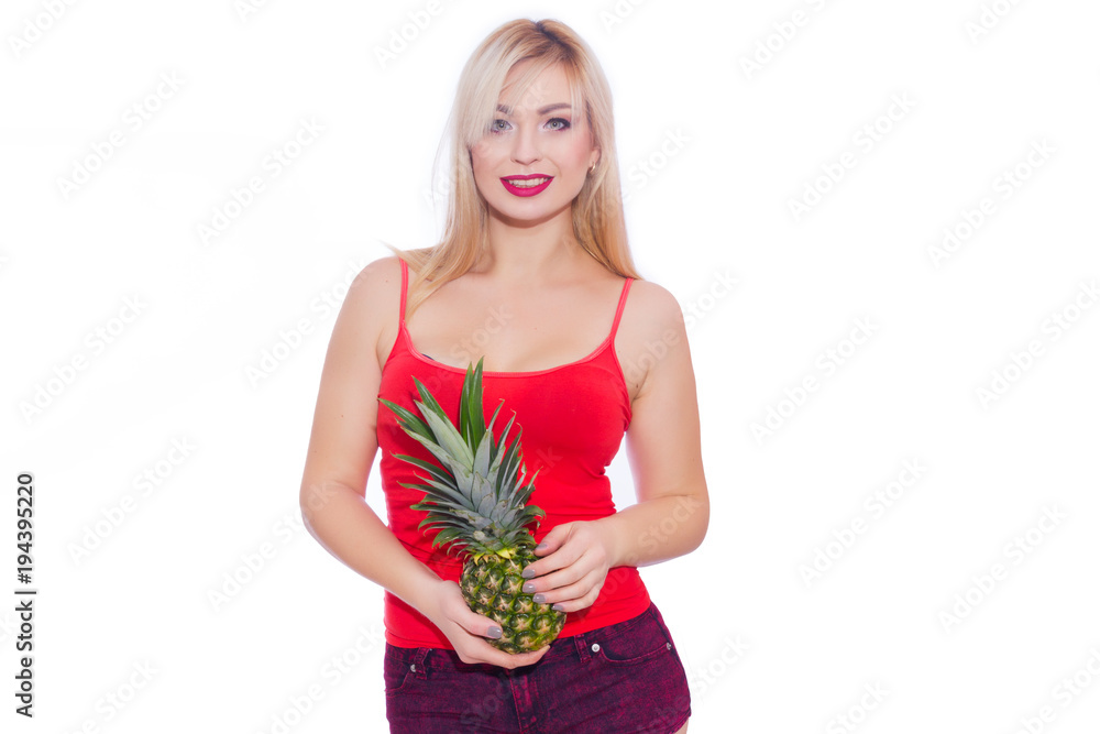 Beautiful blonde woman holding two hands with pineapple near waist and smiling at camera. Isolate. Studio portrait Beautiful blonde woman holding two hands with pineapple near waist and smiling at camera. Isolate. Studio portrait