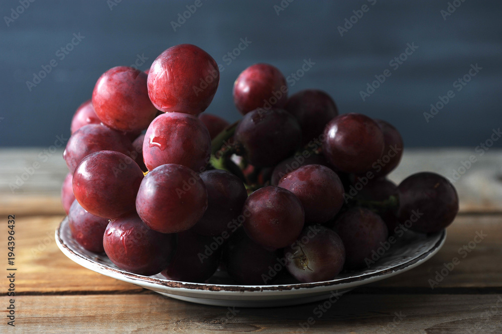 bunch of red grapes on plate bunch of red grapes on plate
