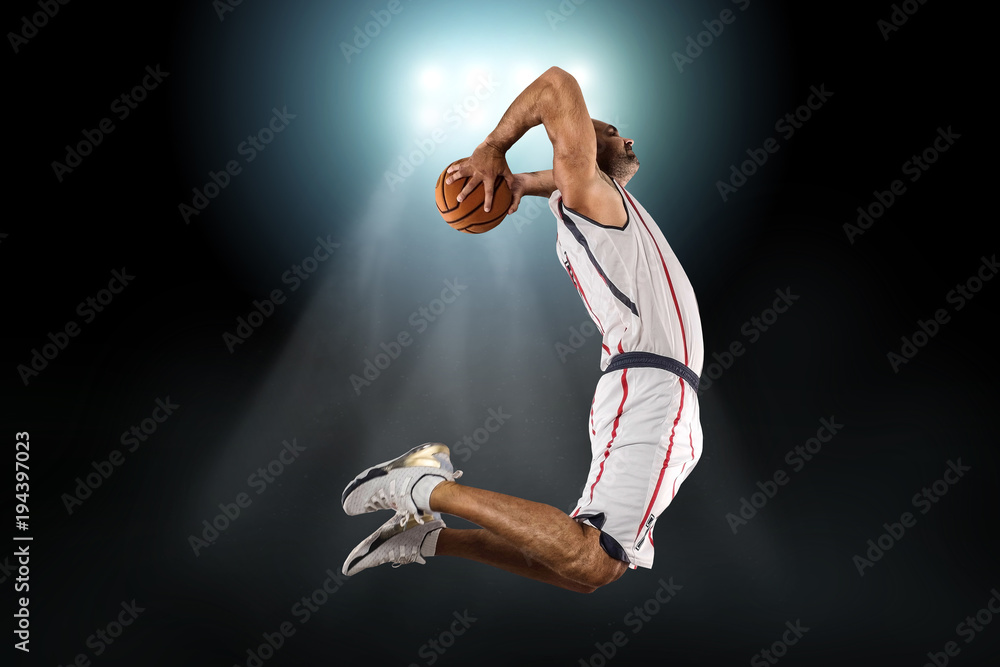 Naklejka premium Caucassian Basketball Player in dynamic action with ball in a pr