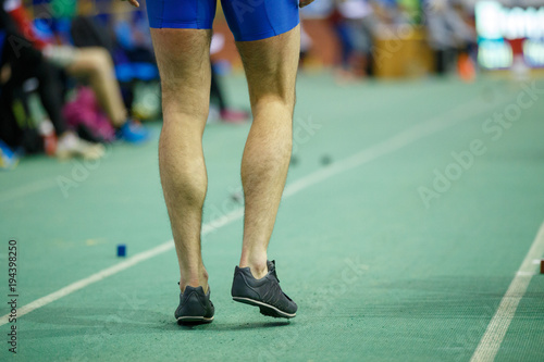 Sportsman getting ready in long jump competition. Track and field competitions concept background photo