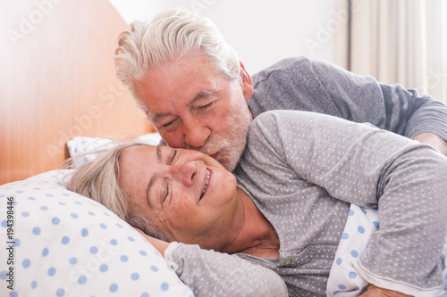 senior couple in love kissing at wake up time